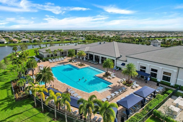 view of pool with a water view and a patio area