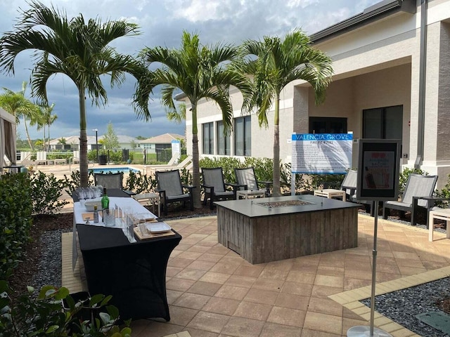 view of patio with a fire pit and a pool