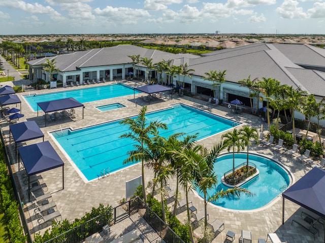 view of pool featuring a hot tub and a patio