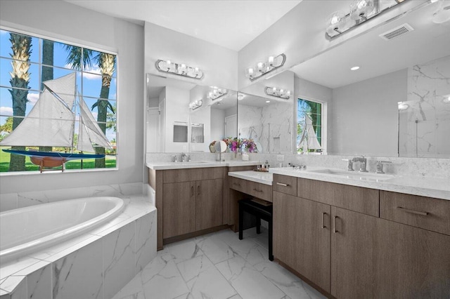 bathroom featuring vanity and a relaxing tiled tub