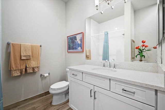 bathroom with vanity, a shower with curtain, wood-type flooring, and toilet