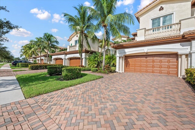 mediterranean / spanish-style house with a garage