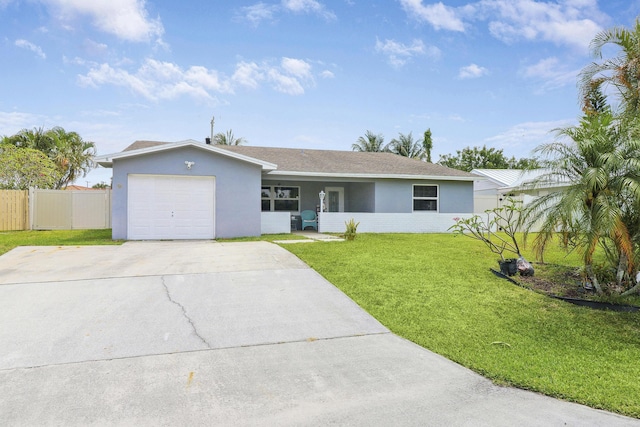 ranch-style home featuring stucco siding, concrete driveway, a front yard, fence, and a garage