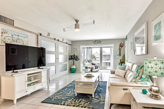 tiled living room featuring ceiling fan