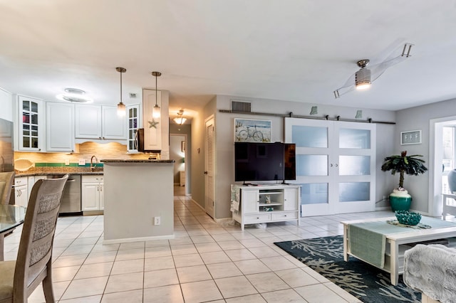 living room with ceiling fan, sink, and light tile patterned floors