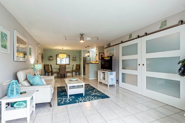 tiled living room featuring a barn door