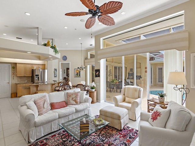 living room with ceiling fan, ornamental molding, and light tile patterned floors