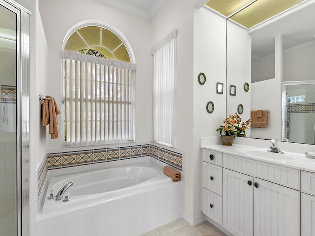 bathroom with tiled bath, ornamental molding, and vanity