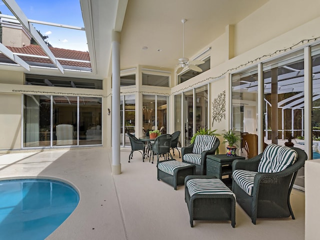 exterior space with glass enclosure and ceiling fan