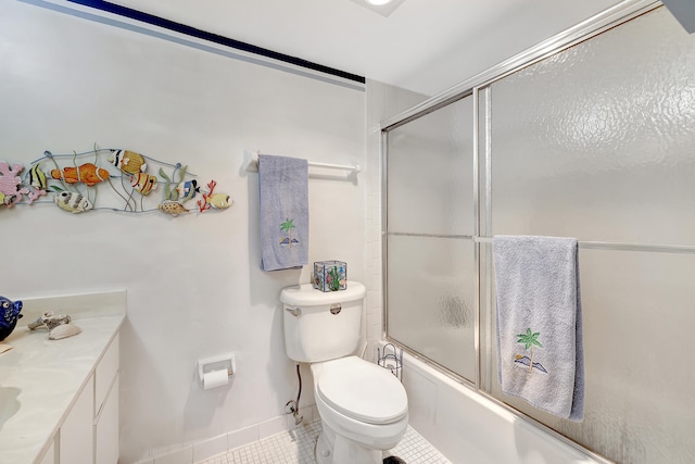 full bathroom featuring vanity, shower / bath combination with glass door, toilet, and tile patterned flooring