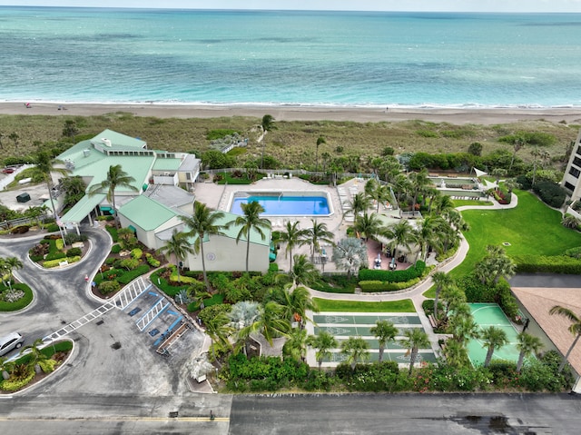 birds eye view of property featuring a water view and a beach view