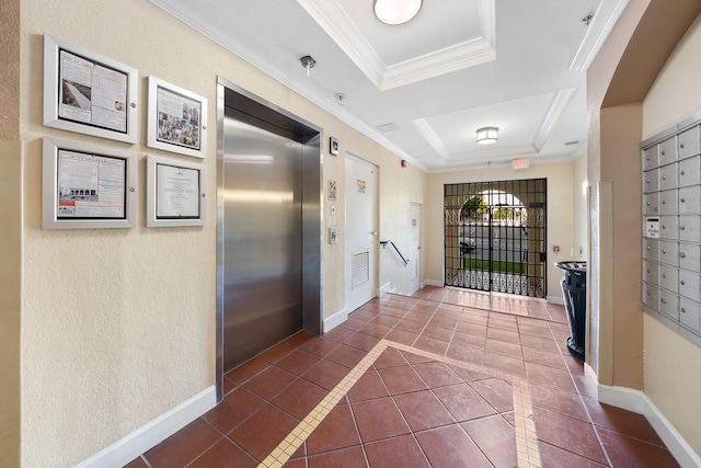 hallway featuring a tray ceiling, crown molding, dark tile patterned floors, and elevator