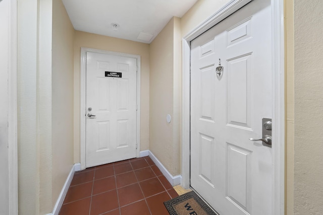 doorway featuring dark tile patterned floors