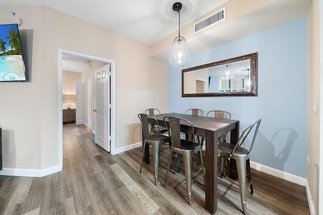 dining area with wood-type flooring