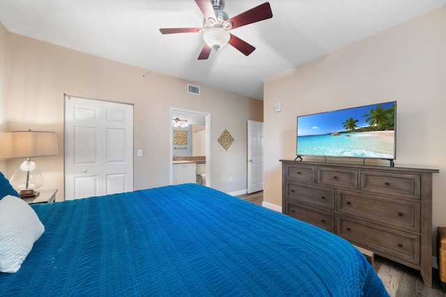 bedroom with light hardwood / wood-style flooring, a closet, ensuite bathroom, and ceiling fan