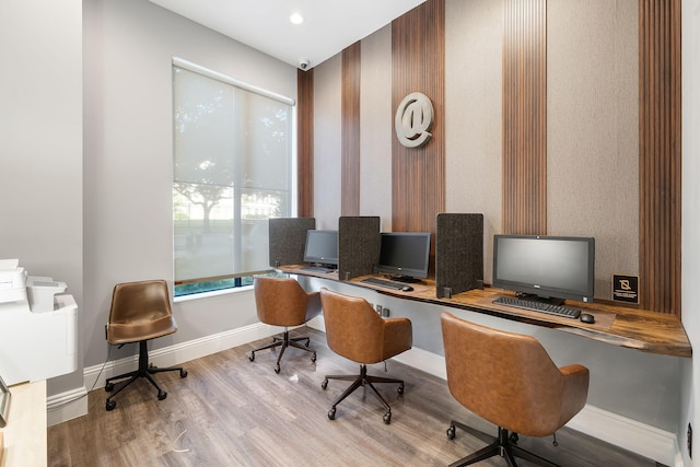 office with light hardwood / wood-style flooring and built in desk