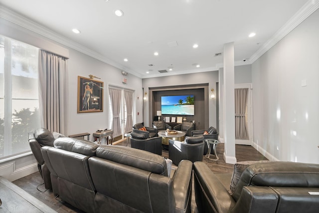 living room featuring hardwood / wood-style flooring, ornamental molding, and a healthy amount of sunlight