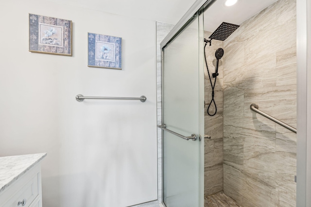 bathroom featuring vanity and an enclosed shower