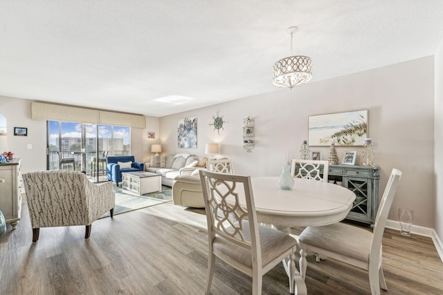 dining room featuring an inviting chandelier and light wood-type flooring