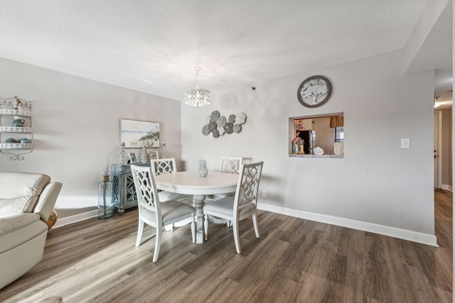 dining room featuring a textured ceiling, a chandelier, and hardwood / wood-style floors