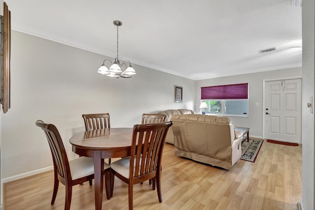 5540 N Ocean Blvd Unit 204, Ocean Ridge, FL 33435 - dining space with a chandelier, ornamental molding, light wood-type flooring, and baseboards