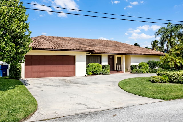 view of front of home featuring a garage and a front lawn