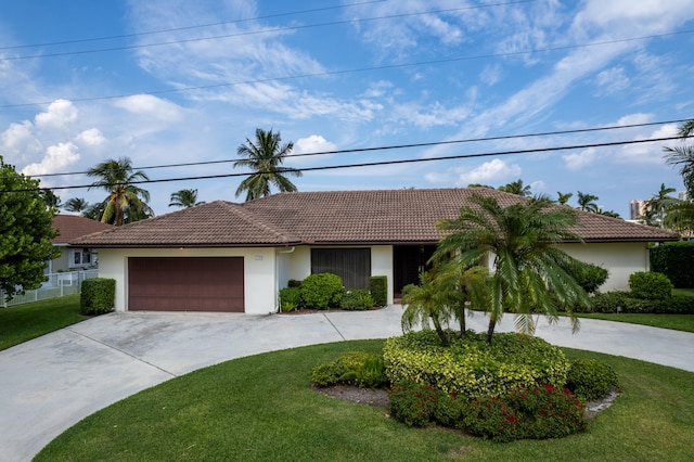 view of front of property with a front yard and a garage