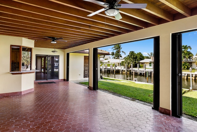 view of patio / terrace featuring a water view and ceiling fan