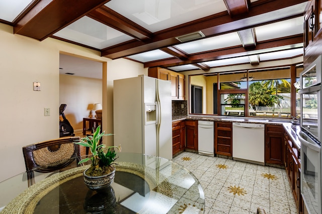 kitchen with decorative backsplash, beamed ceiling, coffered ceiling, and white appliances