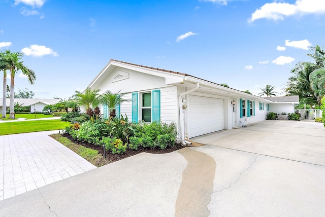 ranch-style house featuring a front lawn and a garage