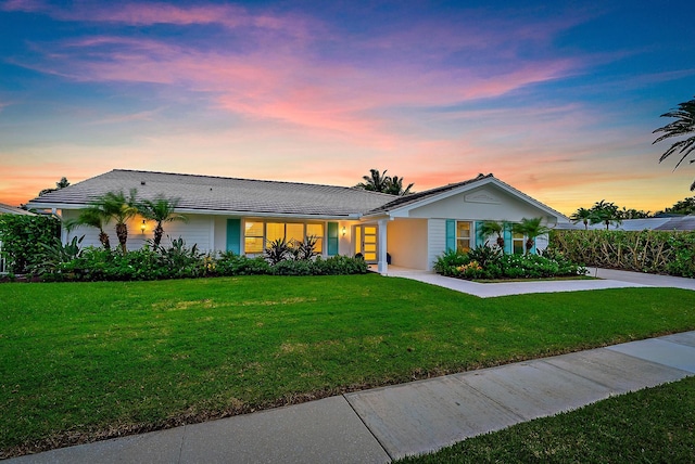 ranch-style house featuring a yard