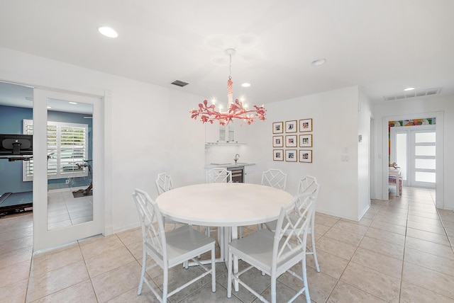 dining area featuring a notable chandelier and light tile patterned floors