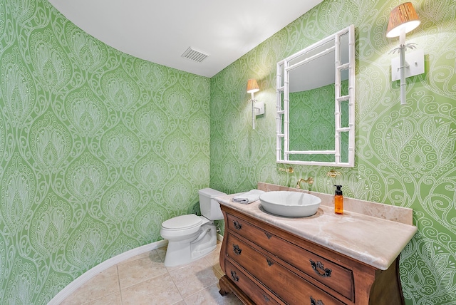 bathroom featuring toilet, vanity, and tile patterned floors