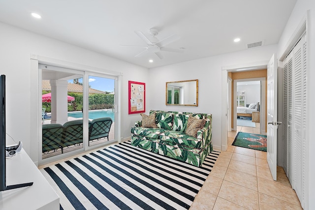 bedroom with light tile patterned flooring, access to exterior, a closet, and ceiling fan