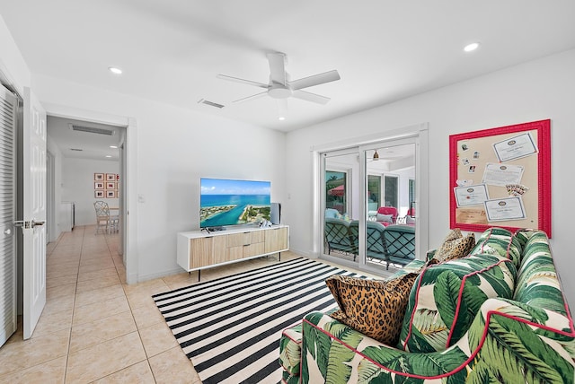 living room featuring light tile patterned floors and ceiling fan