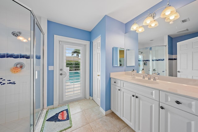 bathroom with vanity, tile patterned flooring, and walk in shower