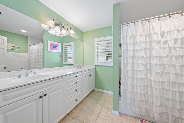 bathroom with vanity, curtained shower, and tile patterned floors