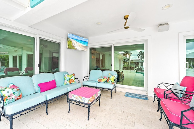 view of patio with an outdoor living space and ceiling fan