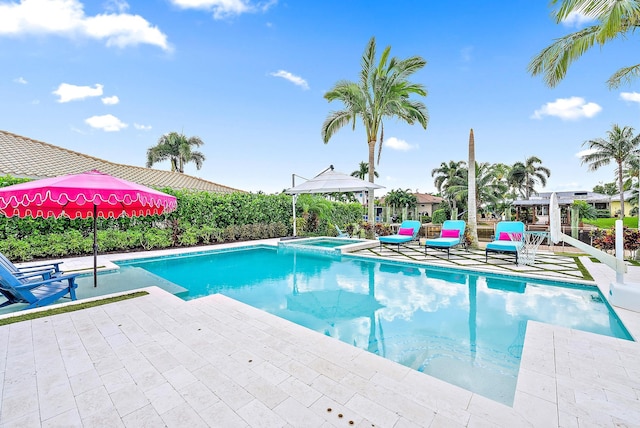 view of pool with a patio and an in ground hot tub