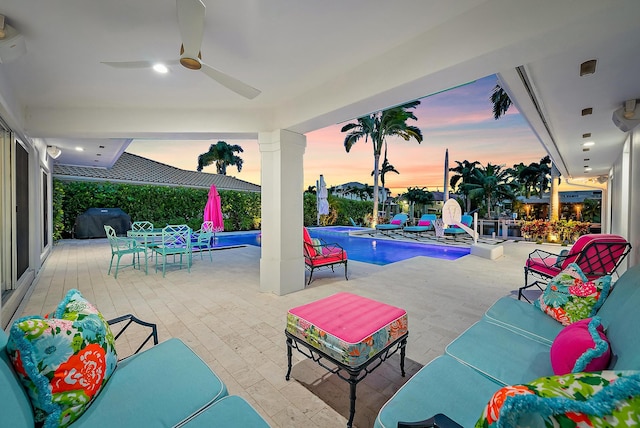 patio terrace at dusk with ceiling fan and a grill