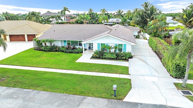 view of front facade with a front yard and a garage