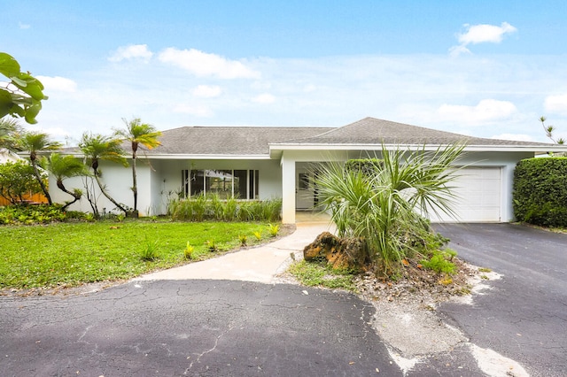 single story home with a front lawn and a garage