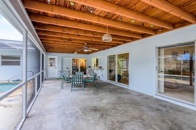 view of patio with glass enclosure and ceiling fan