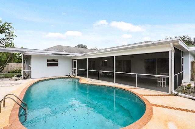 view of pool featuring a patio and a sunroom