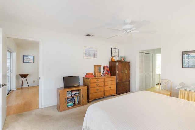 carpeted bedroom featuring a closet and ceiling fan