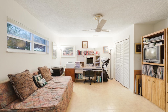 office with ceiling fan and a textured ceiling