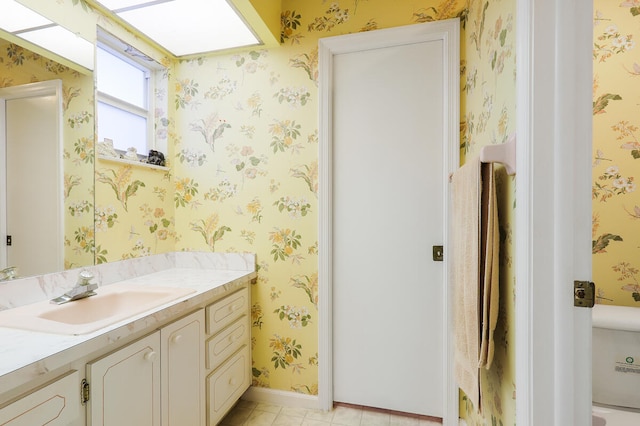 bathroom with vanity, toilet, and tile patterned flooring