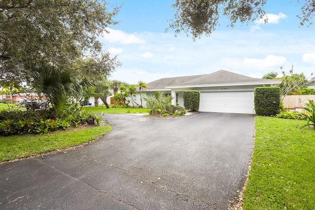 view of front facade with a front yard and a garage