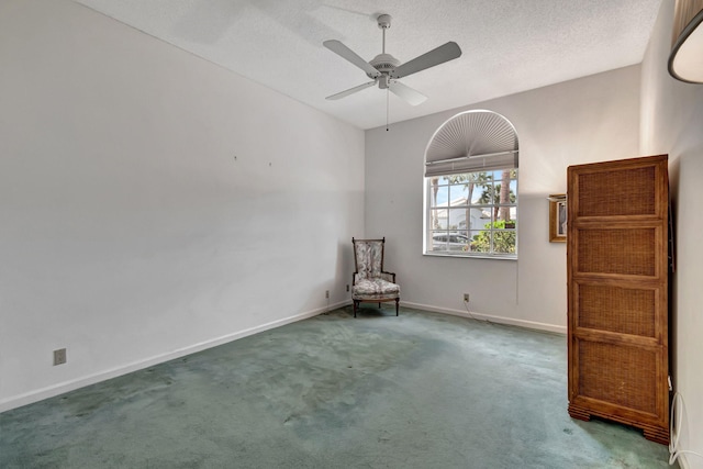 unfurnished room featuring a textured ceiling, carpet flooring, and ceiling fan