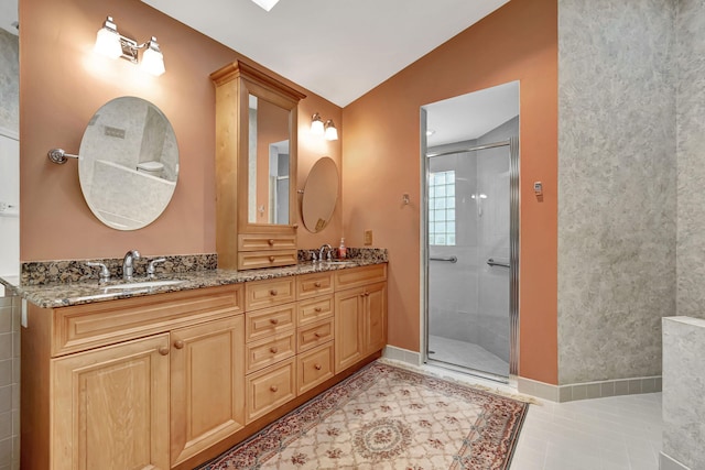 bathroom with vanity, lofted ceiling, tile patterned floors, and a shower with door